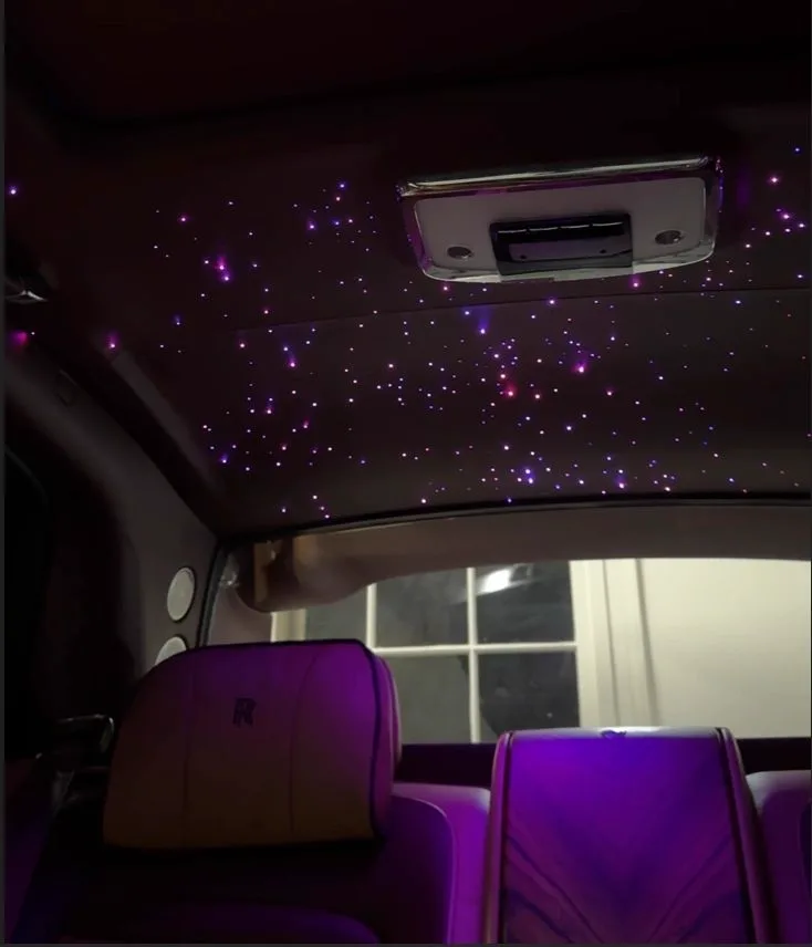 Fiber optic starlight headliner glowing purple in a Rolls-Royce Cullinan interior